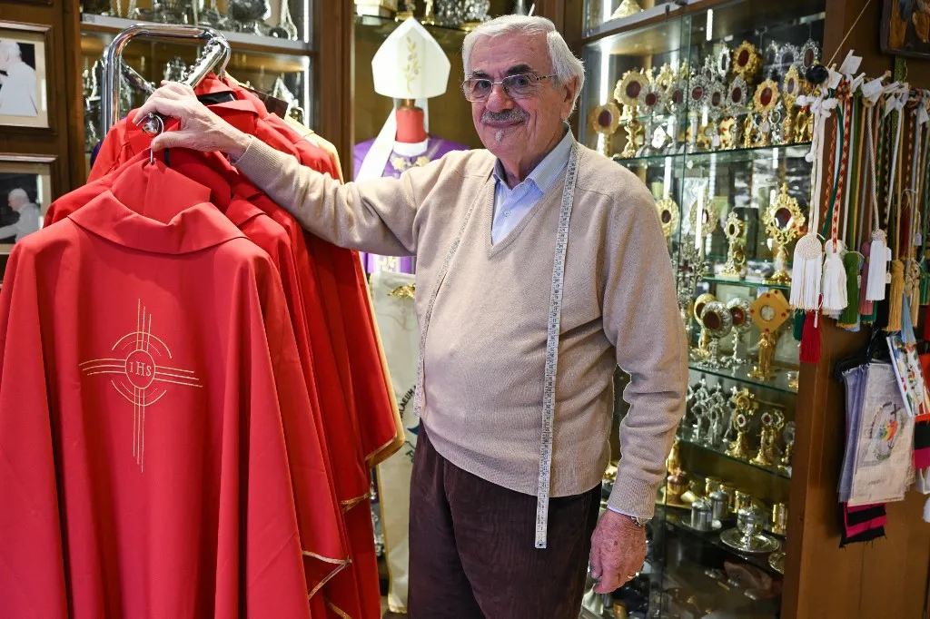 Italian ecclesiastical tailor, Raniero Mancinelli, 86, poses in his shop in Borgo Pio, a neighborhood close to the Vatican, on November 19, 2024. Days have turned into a race against time for Raniero Mancinelli as a third of the 21 prelates who will be made cardinals by Pope Francis on December 7, 2024 have placed orders with him. (Photo by Tiziana FABI / AFP)