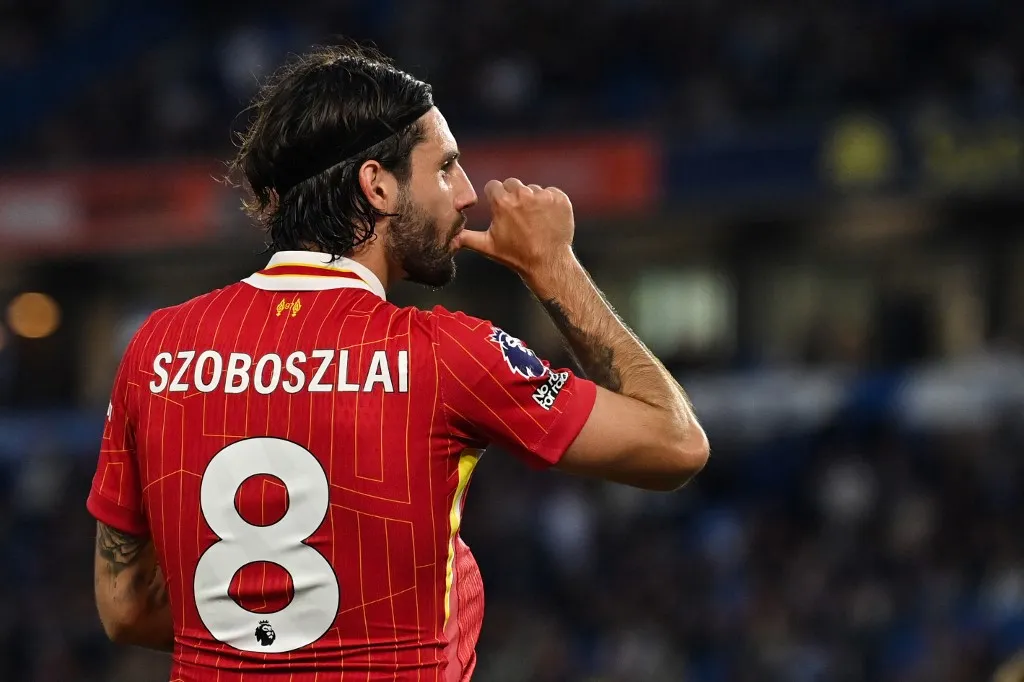 Liverpool's Hungarian midfielder #08 Dominik Szoboszlai celebrates after scoring his team second goal during the English Premier League football match between Brighton and Hove Albion and Liverpool at the American Express Community Stadium in Brighton, southern England on May 19, 2025. (Photo by Glyn KIRK / AFP) / RESTRICTED TO EDITORIAL USE. No use with unauthorized audio, video, data, fixture lists, club/league logos or 'live' services. Online in-match use limited to 120 images. An additional 40 images may be used in extra time. No video emulation. Social media in-match use limited to 120 images. An additional 40 images may be used in extra time. No use in betting publications, games or single club/league/player publications. / 