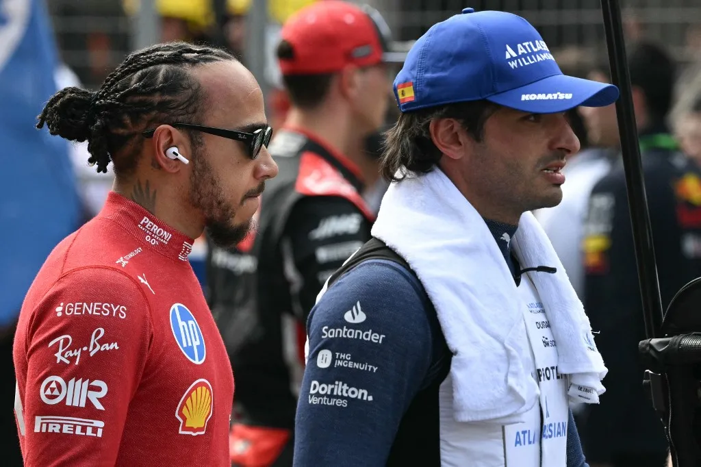 Ferrari's British driver Lewis Hamilton (L) and Williams' Spanish driver Carlos Sainz are seen before the Formula One Chinese Grand Prix at the Shanghai International Circuit in Shanghai on March 23, 2025. (Photo by Greg Baker / AFP)