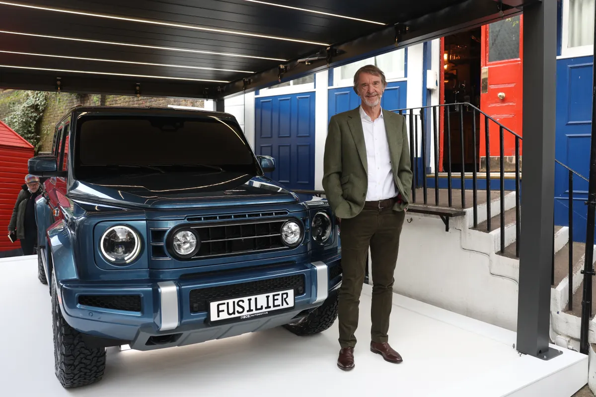 British INEOS Group chairman Jim Ratcliffe poses for a photograph during a media event to unveil the company's "Ineos Fusilier" outside the Grenadier public House in London on February 23, 2024. Manchester United new co-owner Jim Ratcliffe unveiled Friday his Ineos group's latest 4x4 electric vehicle, while calling on governments to understand the limitations of climate-friendly vehicles. (Photo by Daniel LEAL / AFP)