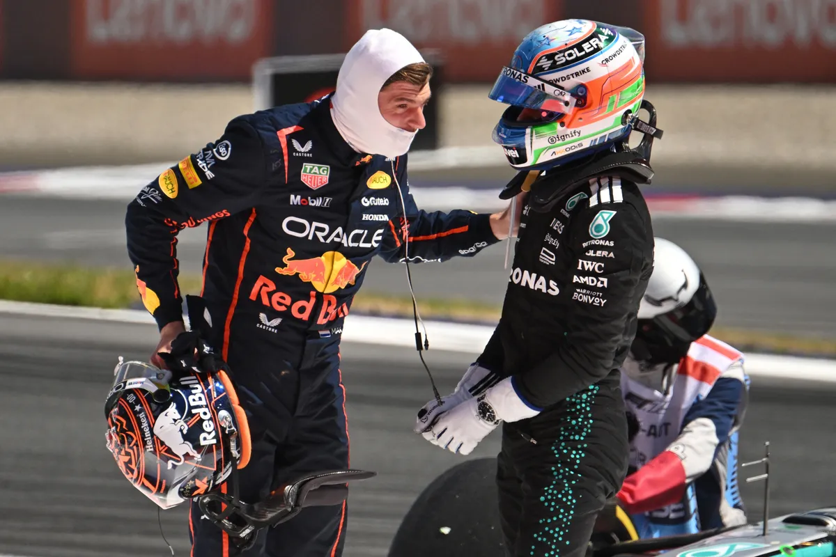 Red Bull's Dutch driver Max Verstappen (L) and Mercedes' Italian driver Kimi Antonelli speak after their cars crashed during the Formula One Austrian Grand Prix at the Red Bull Ring race track in Spielberg, Austria, on June 29, 2025. (Photo by Jure Makovec / AFP)