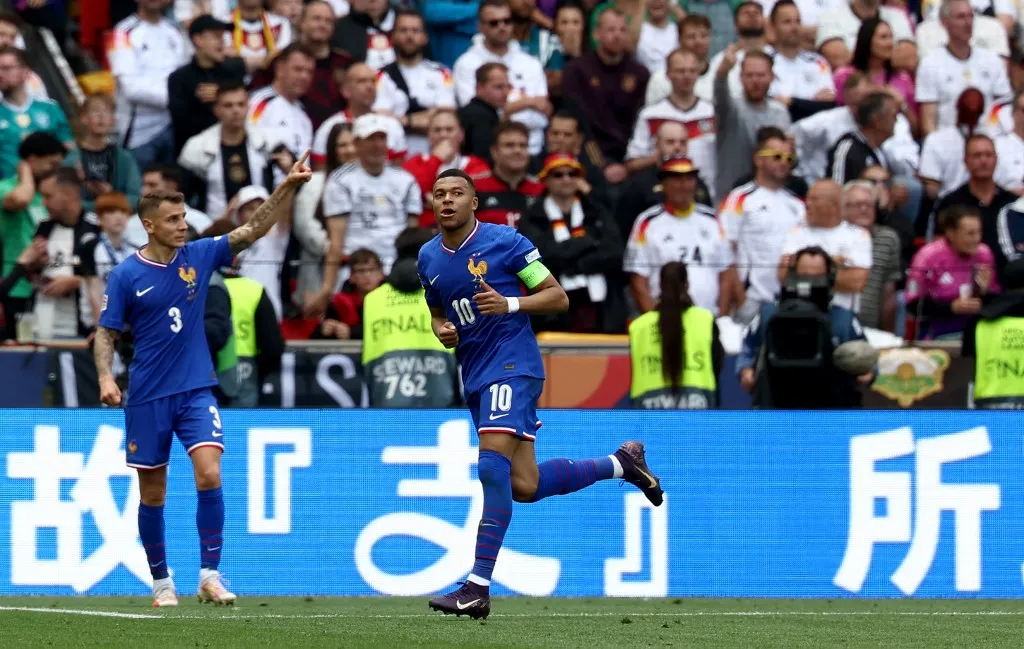 France's forward #10 Kylian Mbappe (R) celebrates after scoring the 0-1 goal during the UEFA Nations League third place play-off football match between Germany and France in Stuttgart, southwestern Germany on June 8, 2025. (Photo by FRANCK FIFE / AFP)