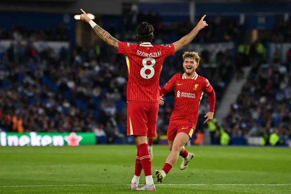 Liverpool's Hungarian midfielder #08 Dominik Szoboszlai celebrates with Liverpool's English midfielder #19 Harvey Elliott after scoring his team second goal during the English Premier League football match between Brighton and Hove Albion and Liverpool at the American Express Community Stadium in Brighton, southern England on May 19, 2025. (Photo by Glyn KIRK / AFP) / RESTRICTED TO EDITORIAL USE. No use with unauthorized audio, video, data, fixture lists, club/league logos or 'live' services. Online in-match use limited to 120 images. An additional 40 images may be used in extra time. No video emulation. Social media in-match use limited to 120 images. An additional 40 images may be used in extra time. No use in betting publications, games or single club/league/player publications. / 