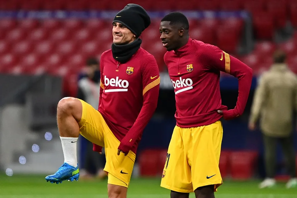 Barcelona's French midfielder Antoine Griezmann (L) and Barcelona's French forward Ousmane Dembele warm up before the Spanish League football match between Club Atletico de Madrid and FC Barcelona at the Wanda Metropolitano stadium in Madrid on November 21, 2020. (Photo by GABRIEL BOUYS / AFP)