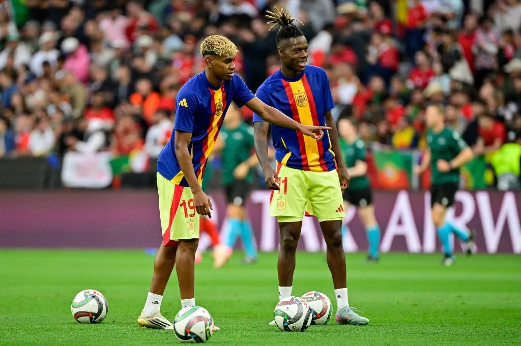 Spain's forward #19 Lamine Yamal (L) and Spain's forward #11 Nico Williams practice shooting during the warm up prior to the UEFA Nations League final football match between Portugal and Spain in Munich, southern Germany on June 8, 2025. (Photo by John MACDOUGALL / AFP)