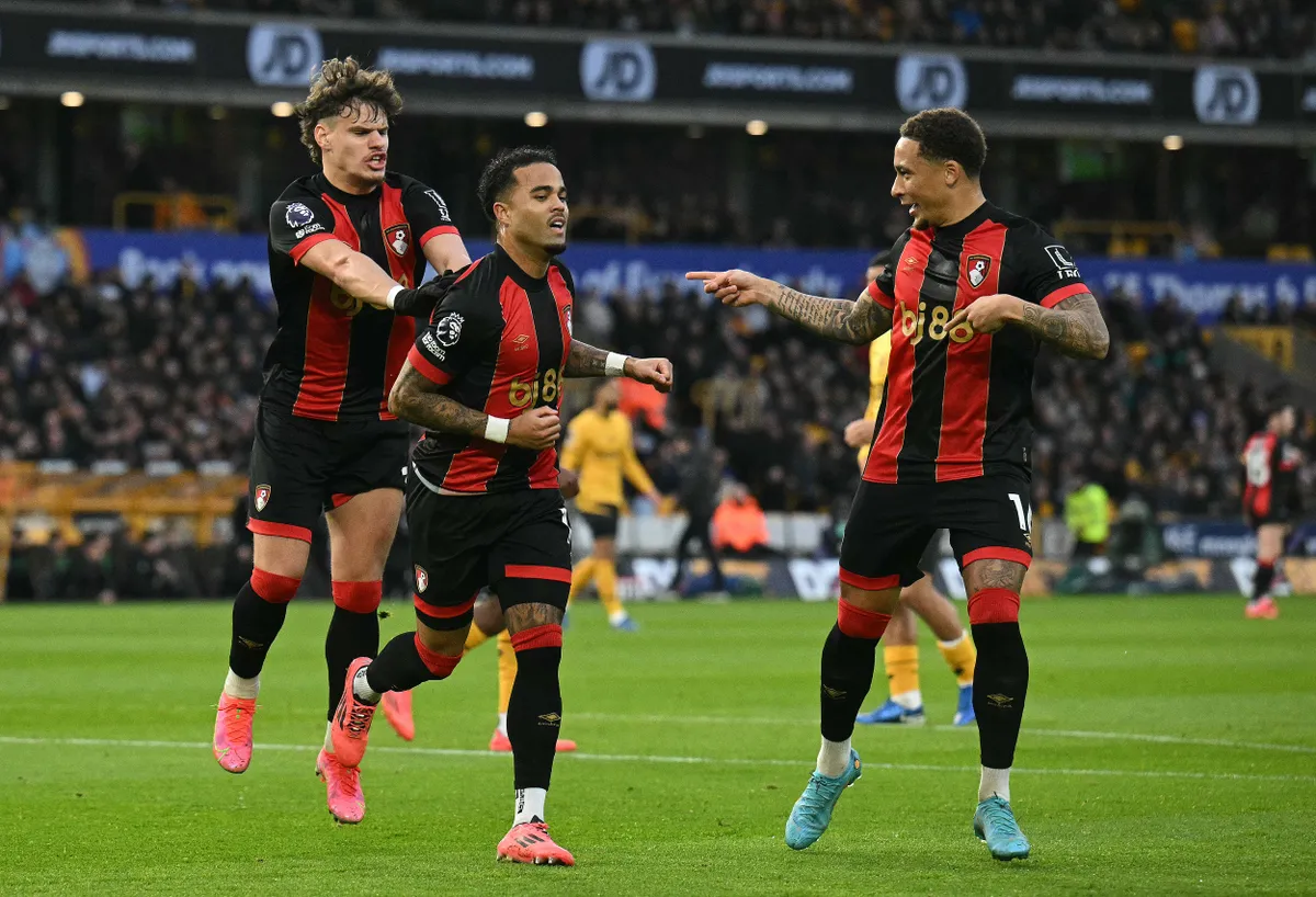 Bournemouth's Dutch striker #19 Justin Kluivert celebrates scoring the team's third goal with Bournemouth's Hungarian defender #03 Milos Kerkez (L) abd Bournemouth's English midfielder #16 Marcus Tavernier during the English Premier League football match between Wolverhampton Wanderers and Bournemouth at the Molineux stadium in Wolverhampton, central England on November 30, 2024. (Photo by Oli SCARFF / AFP) / RESTRICTED TO EDITORIAL USE. No use with unauthorized audio, video, data, fixture lists, club/league logos or 'live' services. Online in-match use limited to 120 images. An additional 40 images may be used in extra time. No video emulation. Social media in-match use limited to 120 images. An additional 40 images may be used in extra time. No use in betting publications, games or single club/league/player publications. / 