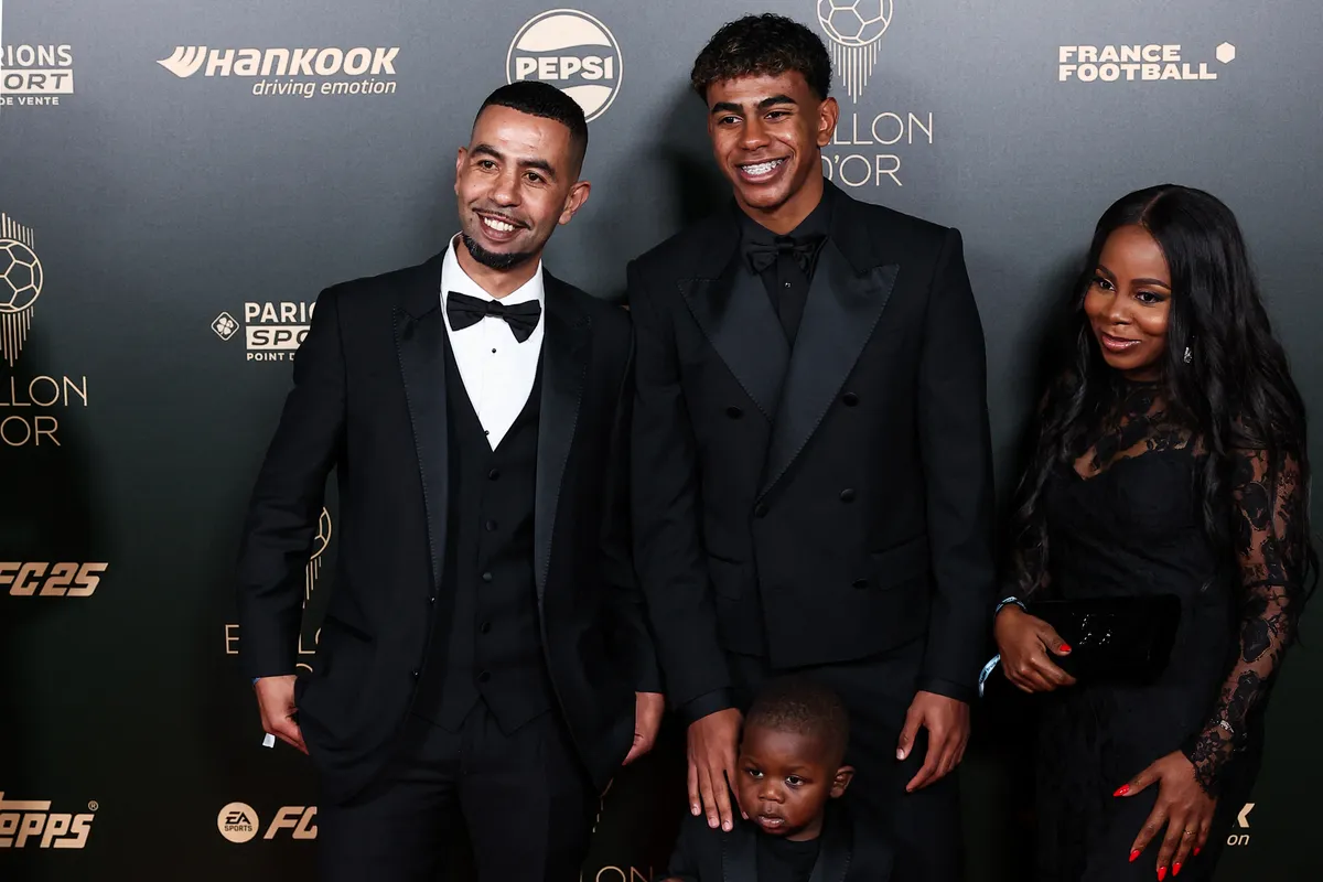Barcelona's Spanish forward Lamine Yamal and his father Mounir Nasraoui, his mother Sheila Ebana and his younger brother Keyne pose upon arrival to attend the 2024 Ballon d'Or France Football award ceremony at the Theatre du Chatelet in Paris on October 28, 2024. (Photo by FRANCK FIFE / AFP)