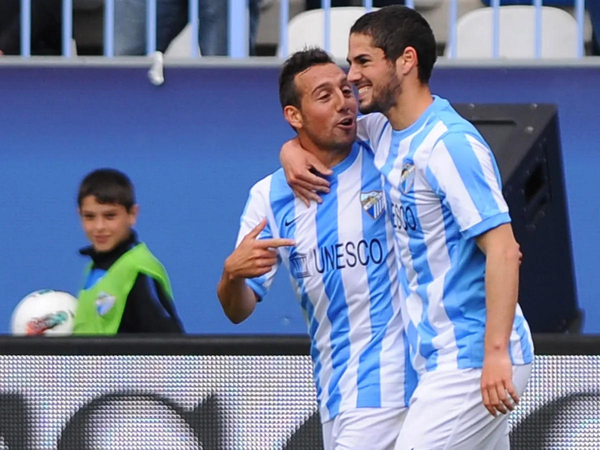 Malaga's midfielder Isco (R) celebrates with midfielder Santiago Cazorla (L) after scoring a goal during the Spanish league football match Malaga CF vs Real Sociedad on April 15, 2012 at Rosaleda stadium in Malaga.    AFP PHOTO/ JORGE GUERRERO (Photo by Jorge Guerrero / AFP)