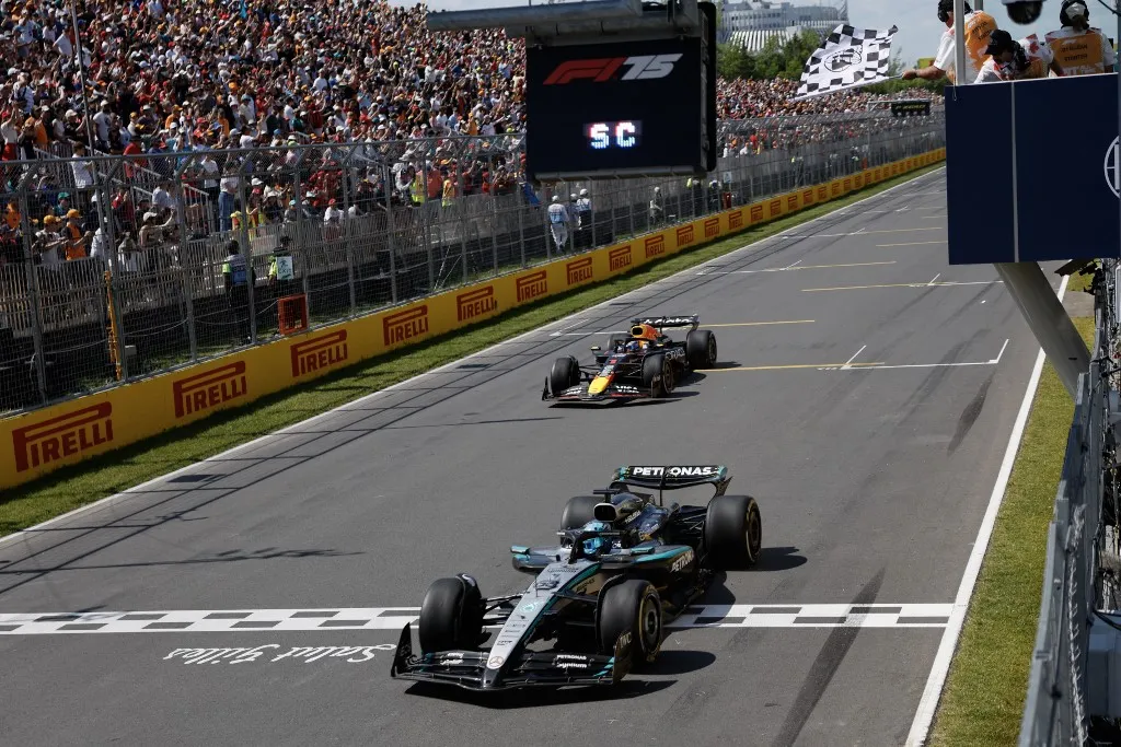 Mercedes' British driver George Russell crosses the finish line as he wins the race, followed by Red Bull Racing's Dutch driver Max Verstappen in second place, during the 2025 Formula 1 Grand Prix du Canada at Circuit Gilles-Villeneuve in Montreal, Canada, on June 15, 2025. (Photo by SHAWN THEW / POOL / AFP)