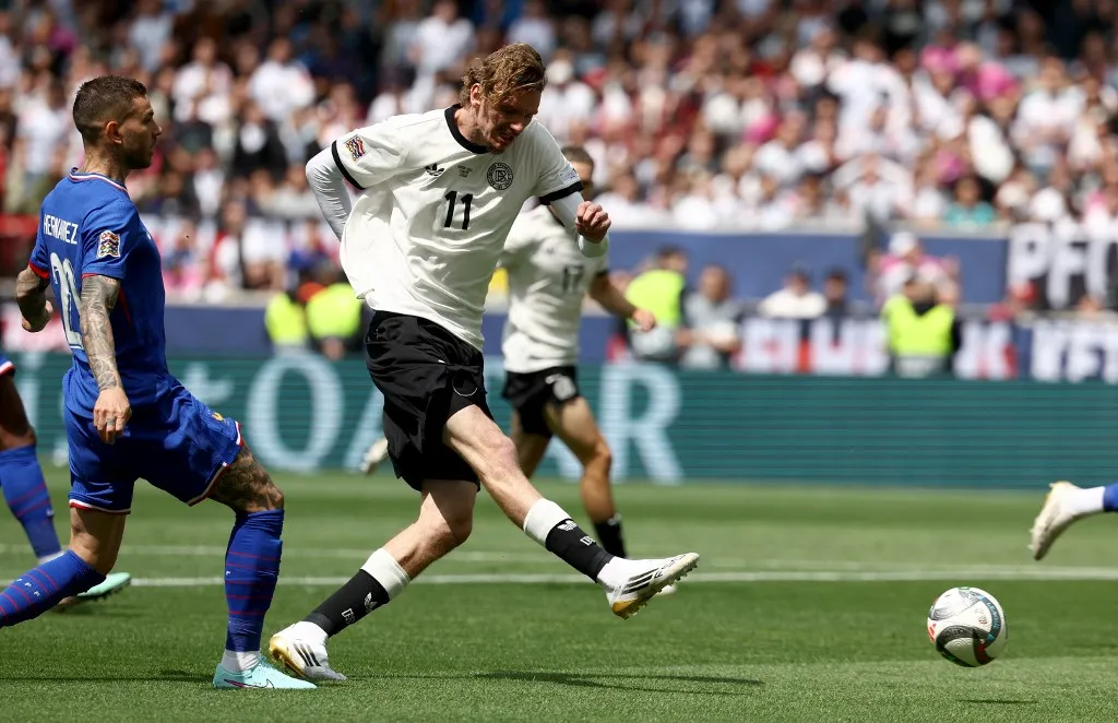 Germany's forward #11 Nick Woltemade (C) and France's defender #21 Lucas Hernandez (L) vie for the UEFA Nations League third place play-off football match between Germany and France in Stuttgart, southwestern Germany on June 8, 2025. (Photo by FRANCK FIFE / AFP)