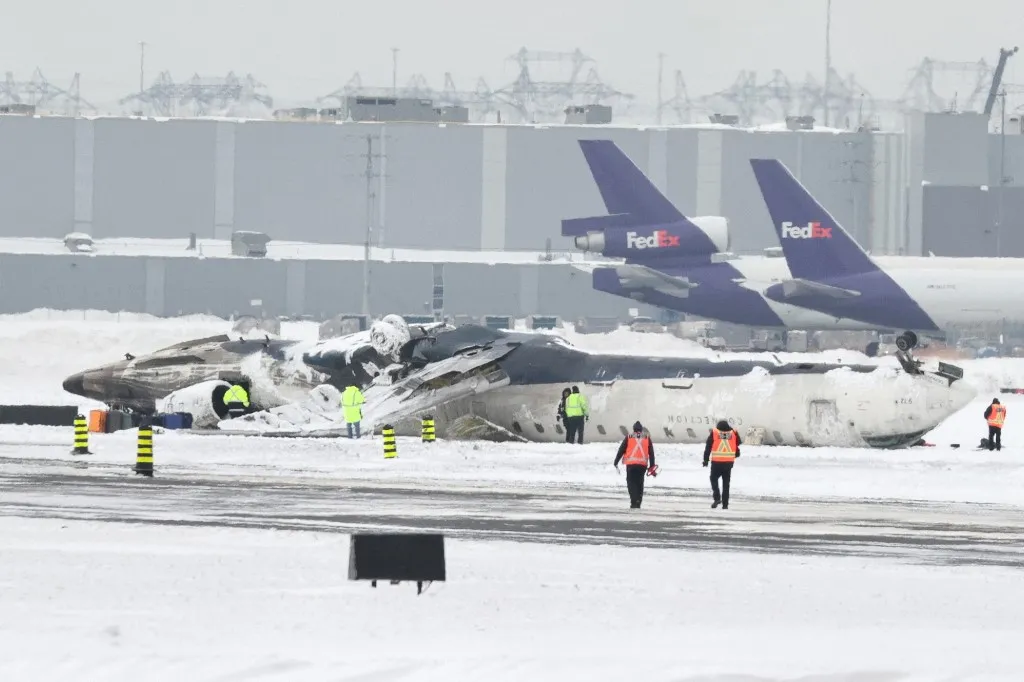 TORONTO, CANADA - FEBRUARY 19 : Wreckage of Delta Airlines plane that crashed upon landing at Toronto Pearson Airport is seen on tarmac as the investigation continues two days after the incident on February 19, 2025. At least 18 people were injured when a Delta Airlines plane crash-landed and flipped upside down at Toronto Pearson International Airport in Canada on Monday. Mert Alper Dervis / Anadolu (Photo by Mert Alper Dervis / Anadolu via AFP)