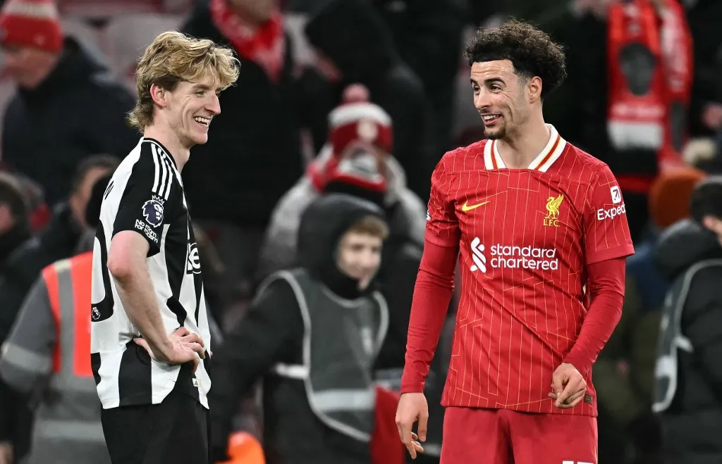 Newcastle United's English midfielder #10 Anthony Gordon (L) and Liverpool's English midfielder #17 Curtis Jones react at the final whistle during the English Premier League football match between Liverpool and Newcastle United at Anfield in Liverpool, north west England on February 26, 2025. Liverpool won the match 2-0. (Photo by Paul ELLIS / AFP) / RESTRICTED TO EDITORIAL USE. No use with unauthorized audio, video, data, fixture lists, club/league logos or 'live' services. Online in-match use limited to 120 images. An additional 40 images may be used in extra time. No video emulation. Social media in-match use limited to 120 images. An additional 40 images may be used in extra time. No use in betting publications, games or single club/league/player publications. / 