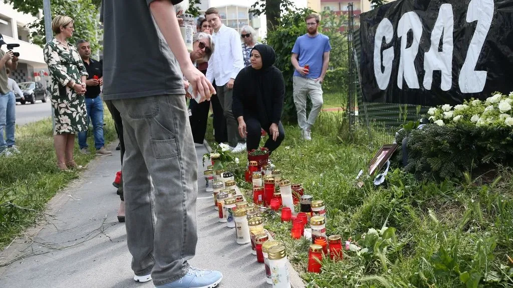 GRAZ, AUSTRIA - JUNE 11: People stand in silence in memory of those who lost their lives at the high school shooting in Graz, in Graz, Austria on June 11, 2025. Askin Kiyagan / Anadolu (Photo by Askin Kiyagan / Anadolu via AFP)