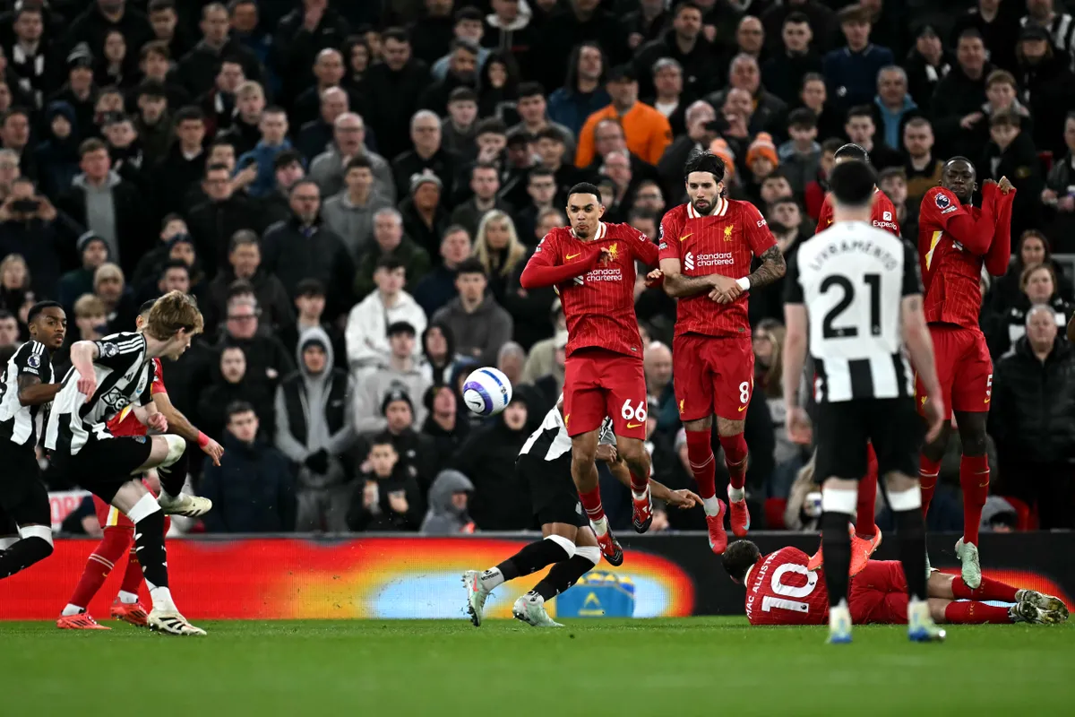 Liverpool's English defender #66 Trent Alexander-Arnold (C) and Liverpool's Hungarian midfielder #08 Dominik Szoboszlai (centre R) defend a free kick during the English Premier League football match between Liverpool and Newcastle United at Anfield in Liverpool, north west England on February 26, 2025. (Photo by Paul ELLIS / AFP) / RESTRICTED TO EDITORIAL USE. No use with unauthorized audio, video, data, fixture lists, club/league logos or 'live' services. Online in-match use limited to 120 images. An additional 40 images may be used in extra time. No video emulation. Social media in-match use limited to 120 images. An additional 40 images may be used in extra time. No use in betting publications, games or single club/league/player publications. / 
