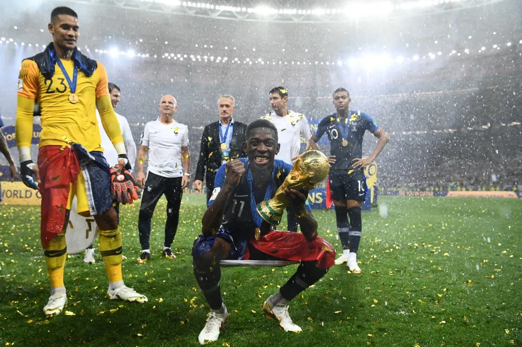 France's forward Ousmane Dembele holds the World Cup trophy after winning the Russia 2018 World Cup final football match between France and Croatia at the Luzhniki Stadium in Moscow on July 15, 2018. (Photo by FRANCK FIFE / AFP) / RESTRICTED TO EDITORIAL USE - NO MOBILE PUSH ALERTS/DOWNLOADS