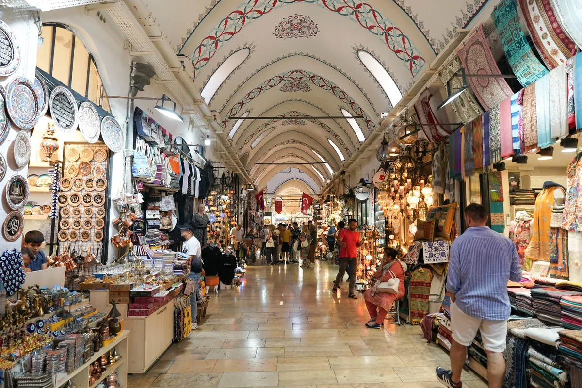 ISTANBUL, TURKIYE - JULY 13, 2023: People shopping in the Grand Bazaar. The Grand Bazaar is one of the largest and oldest covered markets in the world.