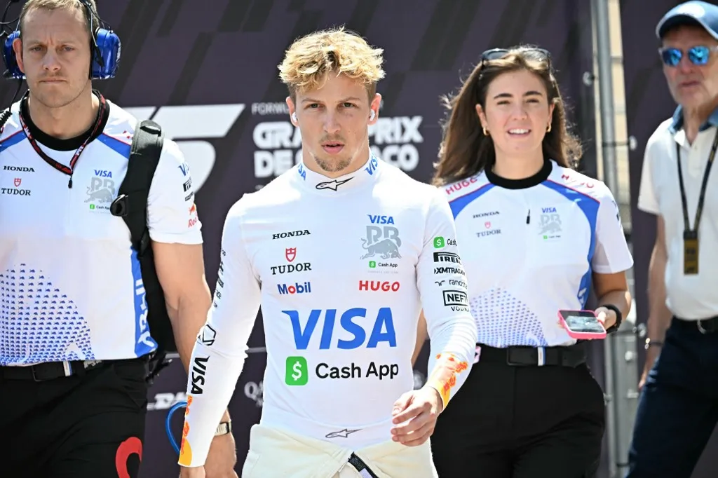 RB's New Zealand driver Liam Lawson (CL) arrives at the track ahead of the third practice session for the Formula One Monaco Grand Prix at the Circuit de Monaco, on May 24, 2025. (Photo by Gabriel BOUYS / AFP)