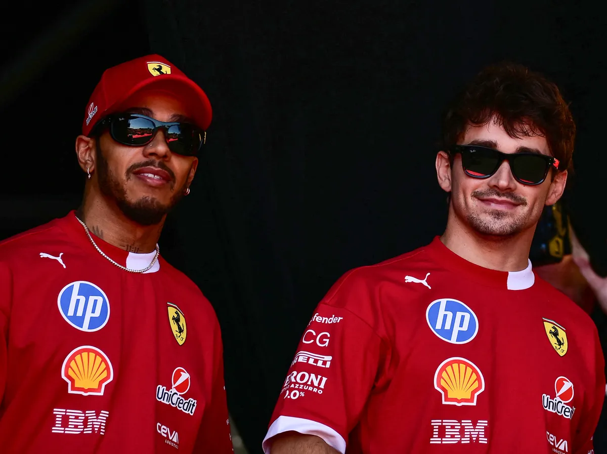 Ferrari's British driver Lewis Hamilton (L) and Ferrari's Monegasque driver Charles Leclerc arrive in the fan zone before a practice session for the 2025 Emilia Romagna Formula One Grand Prix at the Imola autodrome in Imola, on May 17, 2025. (Photo by Marco BERTORELLO / AFP)