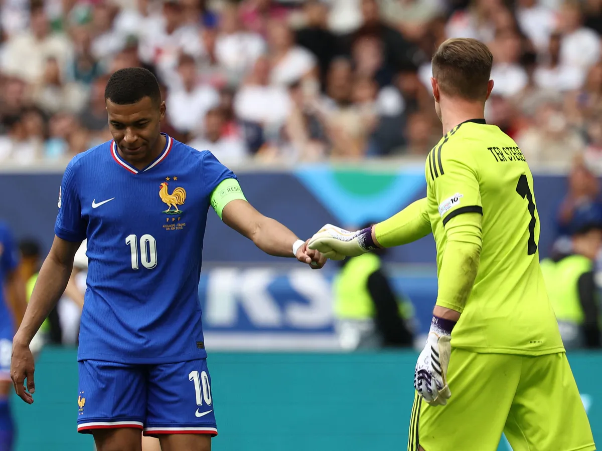 France's forward #10 Kylian Mbappe (L) interacts with Germany's goalkeeper #01 Marc-Andre Ter Stegen during the UEFA Nations League third place play-off football match between Germany and France in Stuttgart, southwestern Germany on June 8, 2025. (Photo by FRANCK FIFE / AFP)