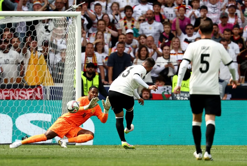 Germany's forward #13 Deniz Undav (C) scores against France's goalkeeper #16 Mike Maignan (L) a goal that was disallowed during the UEFA Nations League third place play-off football match between Germany and France in Stuttgart, southwestern Germany on June 8, 2025. (Photo by FRANCK FIFE / AFP)