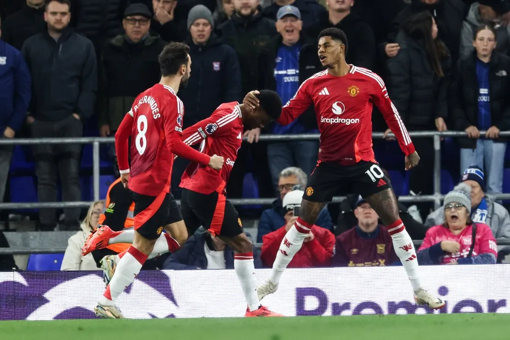Manchester United's English striker #10 Marcus Rashford (R) celebrates after scoring his team first goal during the English Premier League football match between Ipswich Town and Manchester United at Portman Road in Ipswich, eastern England on November 24, 2024. (Photo by Darren Staples / AFP) / RESTRICTED TO EDITORIAL USE. No use with unauthorized audio, video, data, fixture lists, club/league logos or 'live' services. Online in-match use limited to 120 images. An additional 40 images may be used in extra time. No video emulation. Social media in-match use limited to 120 images. An additional 40 images may be used in extra time. No use in betting publications, games or single club/league/player publications. / 