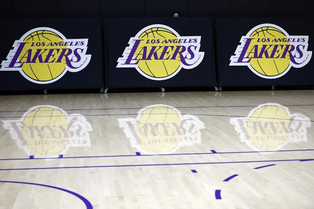 (FILES) The Los Angeles Lakers logo is seen before a press conference at UCLA Health Training Center on September 25, 2024 in El Segundo, California. The Los Angeles Lakers are being sold in a record-breaking $10 billion deal that makes the iconic franchise the highest-valued sports team in US history, ESPN reported on June 18, 2025. (Photo by RONALD MARTINEZ / GETTY IMAGES NORTH AMERICA / AFP)