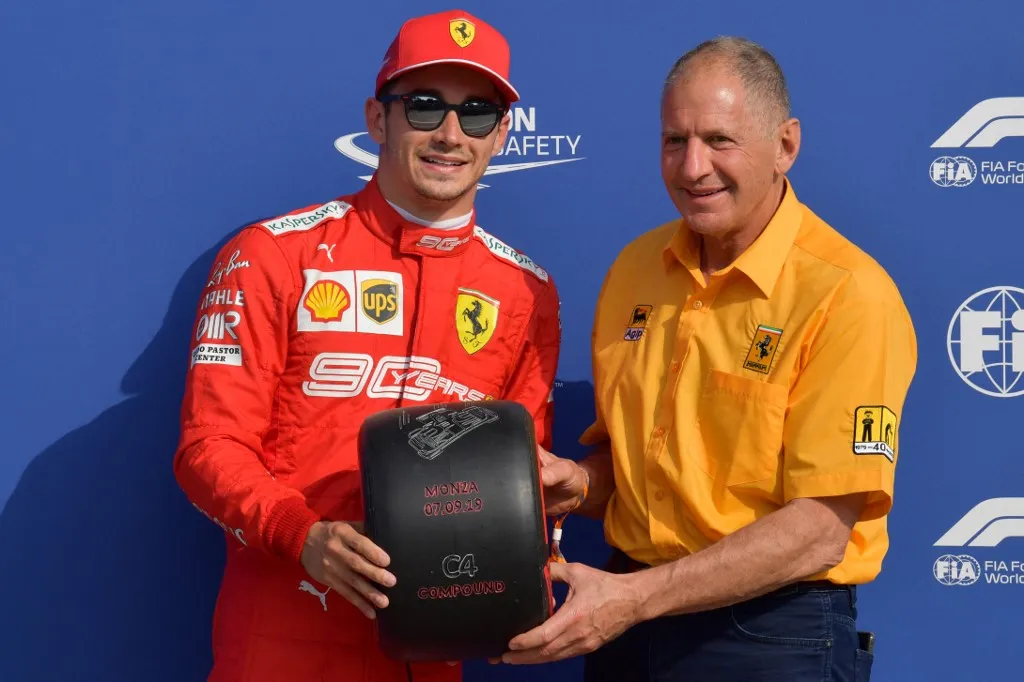 Forma-1 Pole position winner Ferrari's Monegasque driver Charles Leclerc (L) celebrates with Jody Scheckter with South-African former racing driver Jody Scheckter after the qualifying session at the Autodromo Nazionale circuit in Monza on September 7, 2019 ahead of the Italian Formula One Grand Prix. (Photo by Andrej ISAKOVIC / AFP)