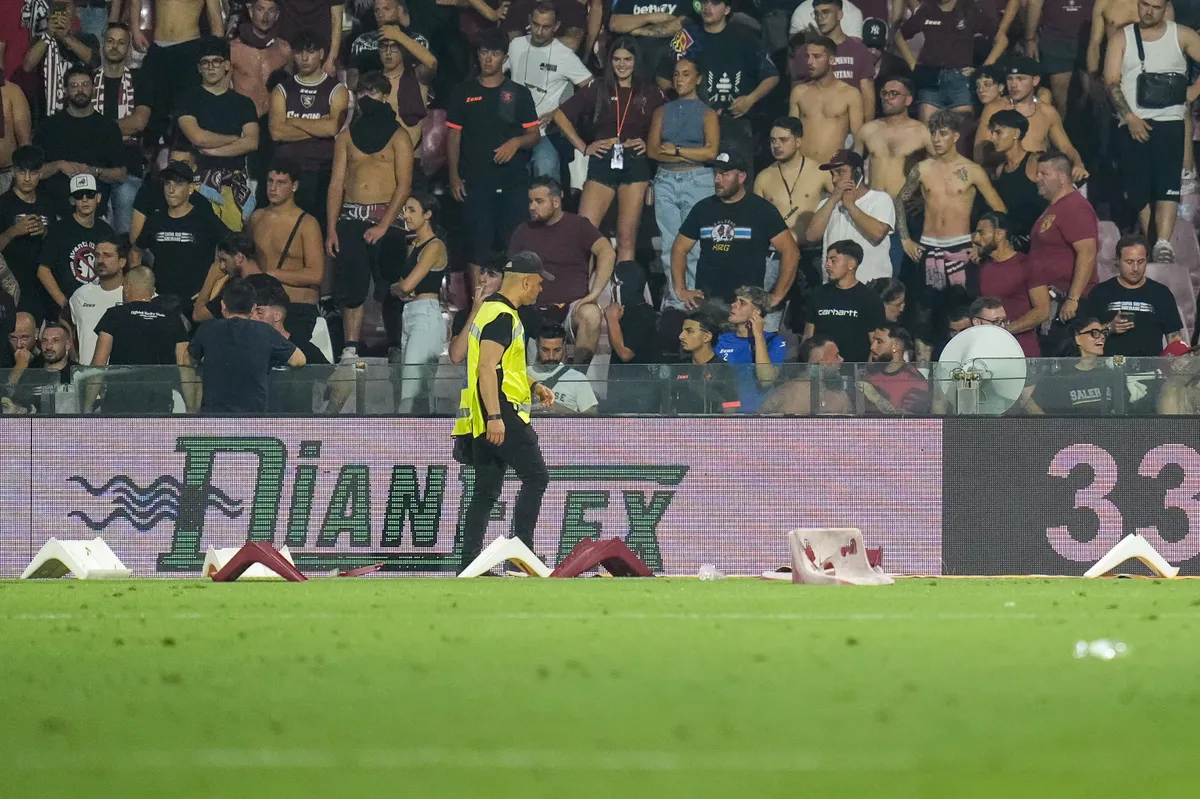 A steward picks up seats thrown by US Salernitana supporters during the Serie B Play-Out leg 2 match between US Salernitana and UC Sampdoria at Stadio Arechi on June 22, 2025 in Salerno, Italy. (Photo by Giuseppe Maffia/NurPhoto) (Photo by Giuseppe Maffia / NurPhoto via AFP), botrány