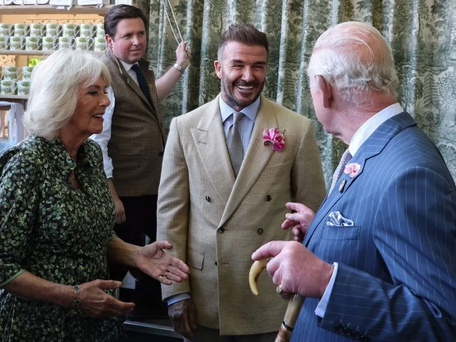 Britain's Queen Camilla (L) and Britain's King Charles III (R) speak with businessman and retired football player David Beckham as they visit the preview day at the RHS Chelsea Flower show, in London, on May 19, 2025.  (Photo by Toby Melville / POOL / AFP)