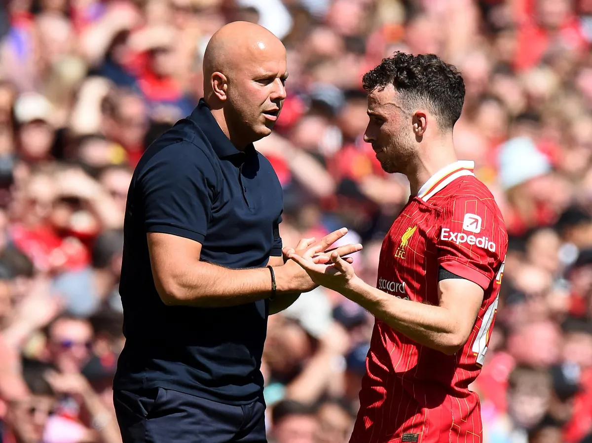 Liverpool's Dutch manager Arne Slot (L) talks to Liverpool's Portuguese striker #20 Diogo Jota during the pre-season friendly football match between Liverpool and Sevilla at Anfield stadium in Liverpool, northwest England on August 11, 2024. (Photo by Peter POWELL / AFP)
