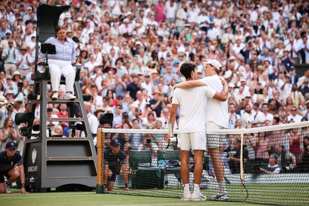 Italy's Jannik Sinner (R) greets Spain's Carlos Alcaraz after winning their men's singles final tennis match on the fourteenth day of the 2025 Wimbledon Championships at The All England Lawn Tennis and Croquet Club in Wimbledon, southwest London, on July 13, 2025. (Photo by HENRY NICHOLLS / AFP) / RESTRICTED TO EDITORIAL USE