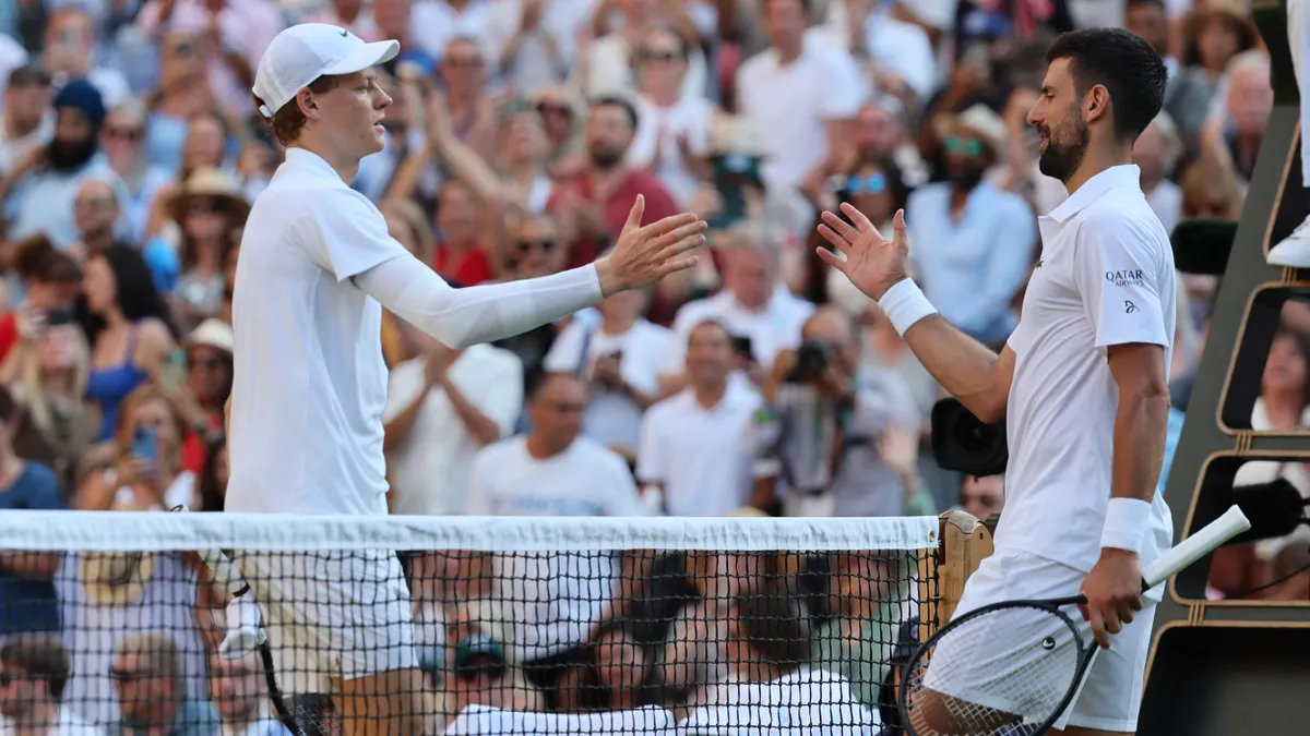 Jannik Sinner of Italy (L) and Novak Djokovic of Serbia congratulate each other on their efforts just after gentlemens singles semi-finals match on day twelfth of the Wimbledon Championships at the All England Lawn Tennis and Croquet Club in London, England on July 11, 2025.      ( The Yomiuri Shimbun ) (Photo by Daisuke Urakami / The Yomiuri Shimbun via AFP)