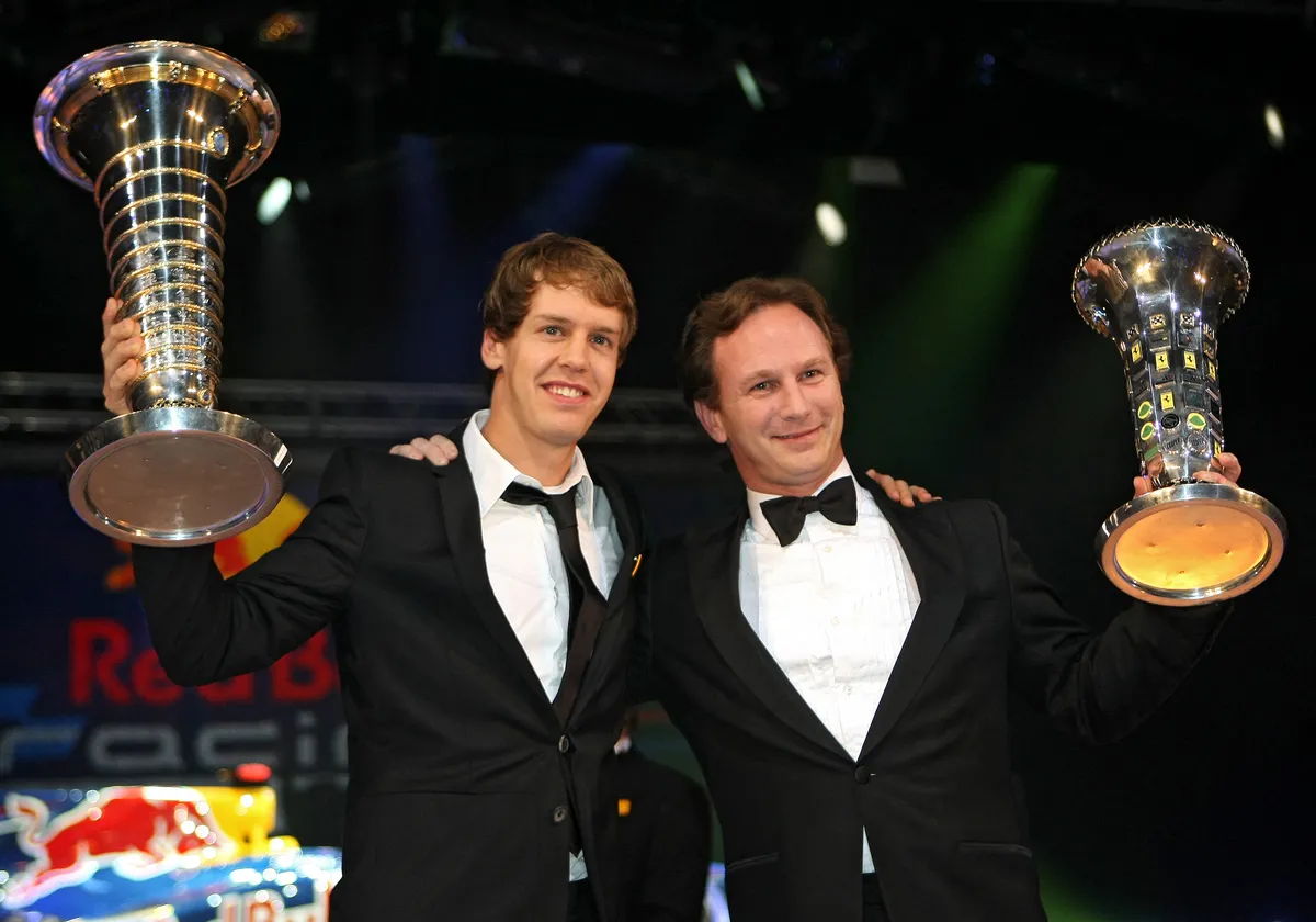 (FILES) 2010 Formula One World Champion Sebastien Vettel (L) of Germany and Red Bull team manager Britain's Christian Horner hold their trophies during the 2010 FIA Prize Giving gala in Monaco on December 10, 2010. Christian Horner is to leave his role as Red Bull team principal with immediate effect after 20 years, the Formula One team announced on July 9, 2025. (Photo by LIONEL CIRONNEAU / POOL / AFP)