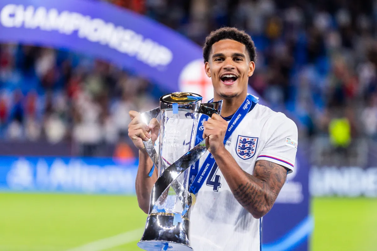 England's defender #04 Jarell Quansah holds the trophy as he celebrates after his team won the UEFA U21 European Championship final football match between England and Germany in Bratislava, Slovakia on June 28, 2025. England successfully defended their Under-21 European Championship title in a 3-2 extra-time victory over Germany in the final. (Photo by Branislav Racko / AFP)