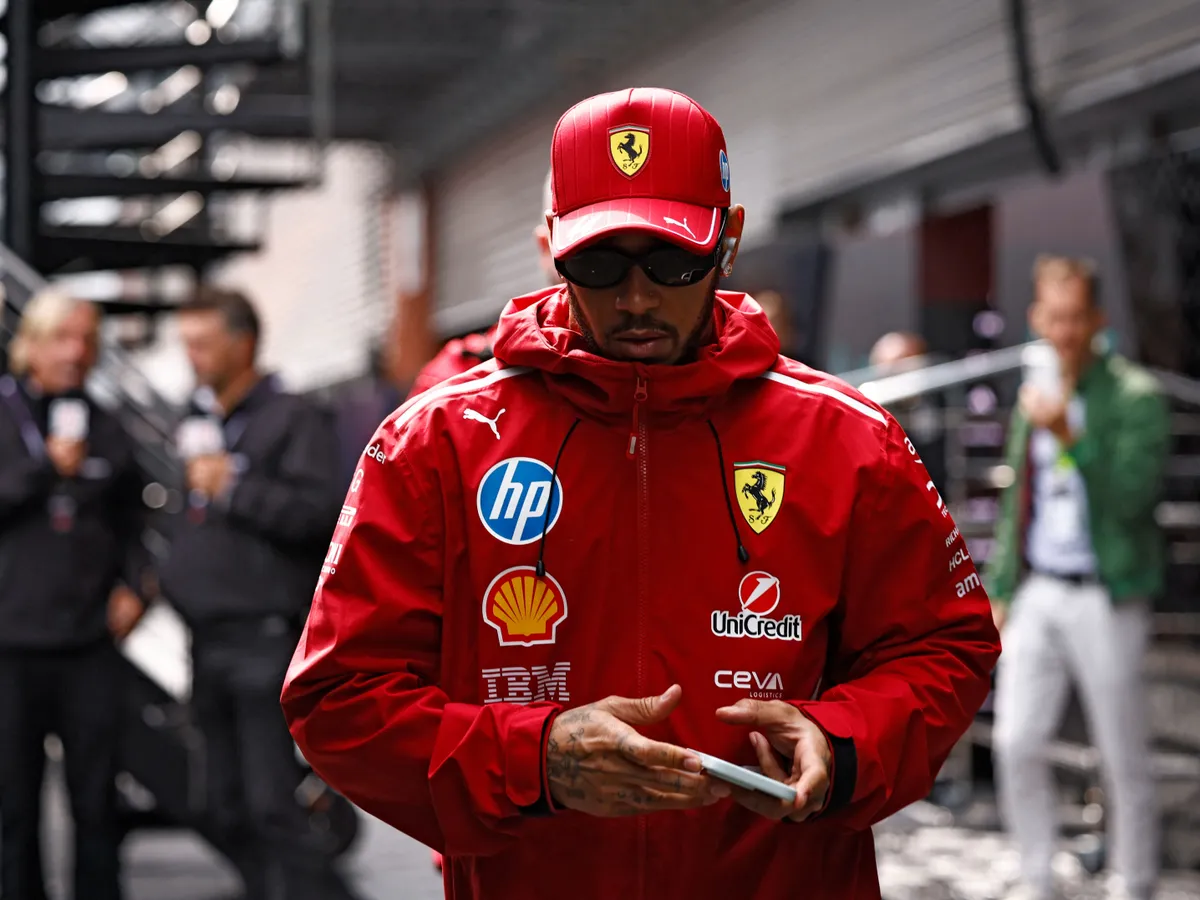 Ferrari's British driver Lewis Hamilton arrives ahead of the start of the Formula One Belgian Grand Prix at the Spa-Francorchamps circuit in Spa, on July 27, 2025. (Photo by SIMON WOHLFAHRT / AFP)