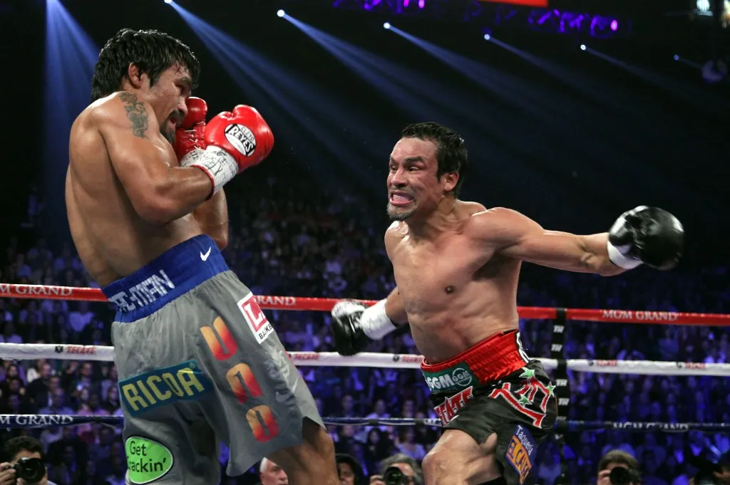 Manny Pacquiao (L) and Juan Manuel Marquez battle during their welterweight fight on December 8, 2012, at the MGM Grand Garden in Las Vegas, Nevada.  Marquez knocked out Pacquiao in the 6th round.    AFP PHOTO / John Gurzinski (Photo by JOHN GURZINSKI / AFP)