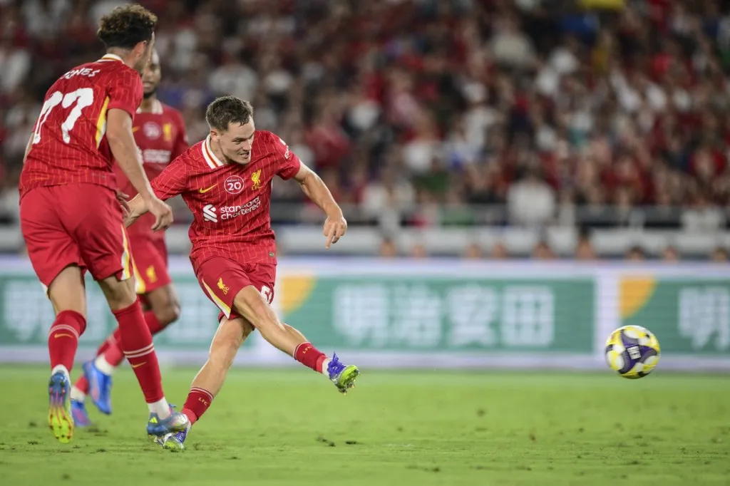 Liverpool's Florian Wirtz (R) scores a goal during the friendly football match between English Premier League side Liverpool and Japan's J-League team Yokohama F. Marinos in Yokohama on July 30, 2025. (Photo by Yuichi YAMAZAKI / AFP)