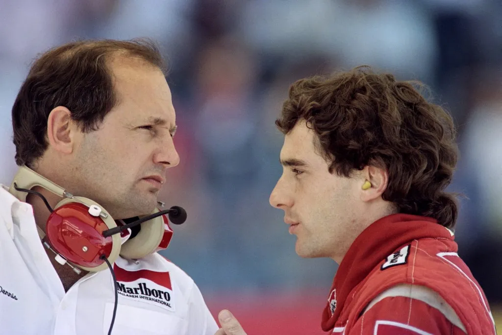Brazilian Formula One pilot Ayrton Senna (R) talks with team manager Ron Dennis on September 24, 1989 after his Mac Laren touched Britain's Nigel Mansell during the Portuguese Grand Prix. (Photo by Jean-Loup GAUTREAU and Pascal PAVANI / AFP)