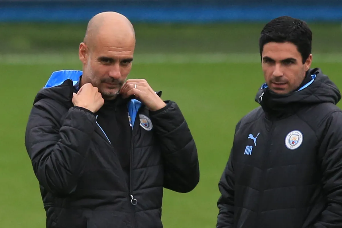 Manchester City's Spanish manager Pep Guardiola (L) and assistant Mikel Arteta (R) attend a team training session at City Football Academy in Manchester, north west England on September 30, 2019, the eve of their UEFA Champions League football Group C match against Dinamo Zagreb. (Photo by Lindsey Parnaby / AFP)