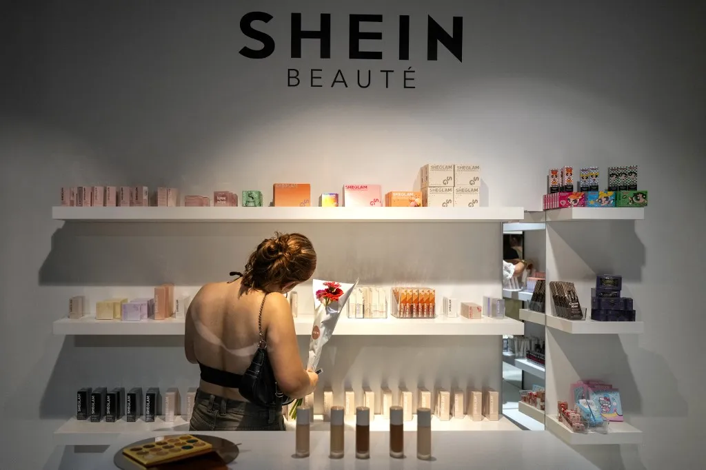 A customer looks at beauty products at a pop-up store of the Chinese-founded fast fashion brand Shein, in Dijon on June 26, 2025. (Photo by ARNAUD FINISTRE / AFP) pop-up bolt