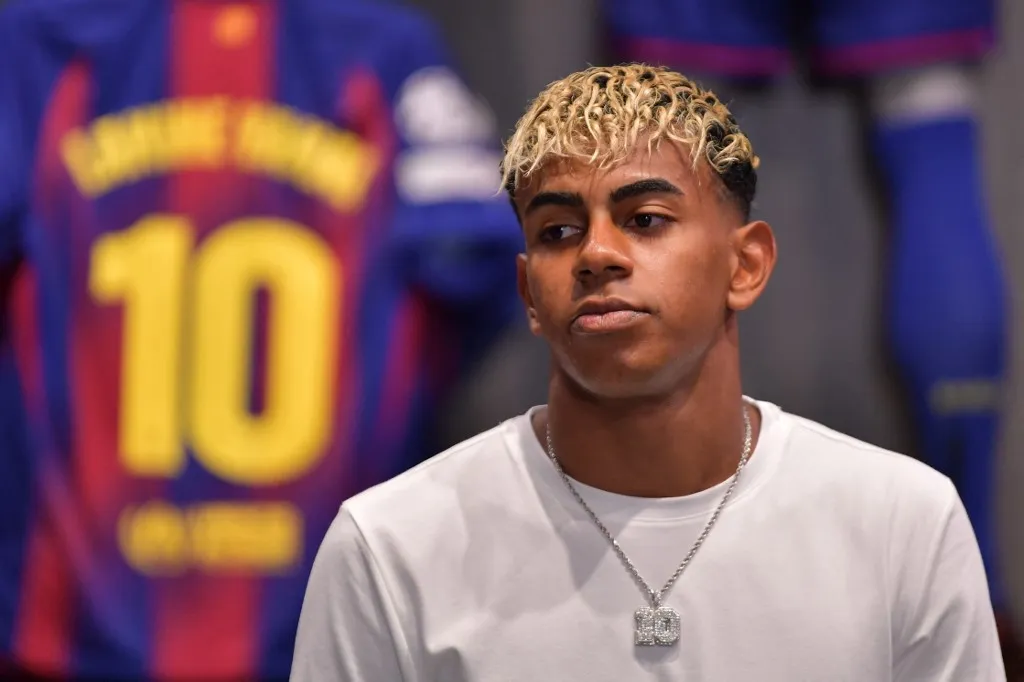 Barcelona's Spanish forward Lamine Yamal attends the presentation of his new #10 jersey at the Camp Nou stadium's shop on July 16, 2025 in Barcelona. Young Barcelona star Lamine Yamal inherited the club's number 10 shirt, previously worn by all-time great Lionel Messi, today. The 18-year-old winger, often compared to the Argentine superstar who also came through the club's La Masia youth academy, helped the Catalan giants win a domestic treble last season. (Photo by MANAURE QUINTERO / AFP)
