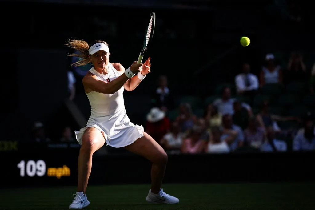 Spain's Paula Badosa plays a forehand return to Britain's Katie Boulter during their women's singles first round tennis match on the first day of the 2025 Wimbledon Championships at The All England Lawn Tennis and Croquet Club in Wimbledon, southwest London, on June 30, 2025. (Photo by HENRY NICHOLLS / AFP) / RESTRICTED TO EDITORIAL USE