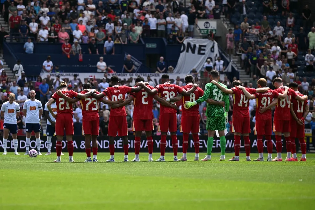 Kerkez Milos, Preston and Liverpool players observe a minute's silence for Liverpool's late Portuguese striker #20 Diogo Jota during the pre-season friendly football match between Preston North End and Liverpool at Deepdale stadium in Preston, north-west England on July 13, 2025. Liverpool are to retire Diogo Jota's number 20 shirt in honour of the Portugal forward who was killed in a car crash this month. The club return to action for the first time since the July 3 tragedy at English Championship side Preston today. (Photo by Oli SCARFF / AFP) / RESTRICTED TO EDITORIAL USE. No use with unauthorized audio, video, data, fixture lists, club/league logos or 'live' services. Online in-match use limited to 120 images. An additional 40 images may be used in extra time. No video emulation. Social media in-match use limited to 120 images. An additional 40 images may be used in extra time. No use in betting publications, games or single club/league/player publications. / 