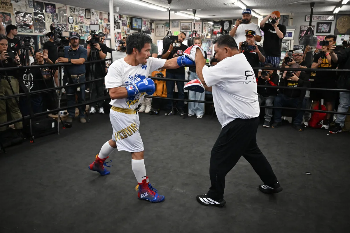Fillipino boxer Manny "Pacman" Pacquiao (L) spars with one of his trainers during a media day workout at Wild Card Boxing Club in Los Angeles on June 25, 2025. Manny Pacquiao will take on US boxer Mario "El Azteca" Barrios for the WBC welterweight title on July 19, 2025, in Las Vegas, Nevada. (Photo by Robyn Beck / AFP)