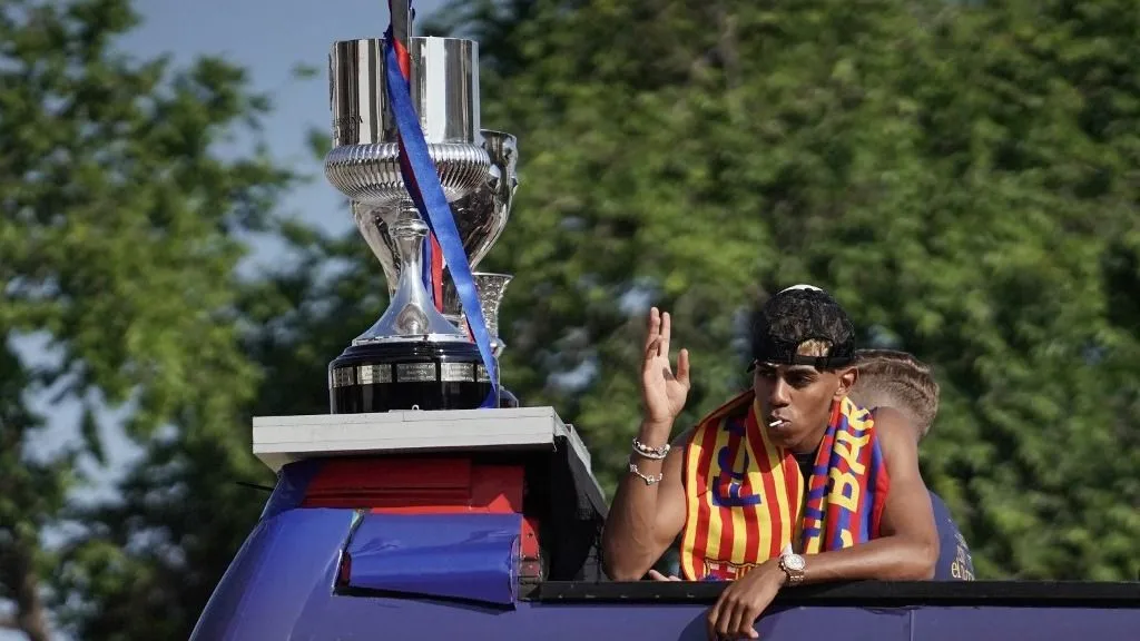 Barcelona's Spanish forward #19 Lamine Yamal waves to supporters from an open top bus as Barcelona players celebrate winning their 28th La Liga title in Barcelona, on May 16, 2025. A stunning Lamine Yamal strike helped crown Barcelona La Liga champions with a 2-0 win at local rivals Espanyol on Thursday, with victory ensuring Real Madrid cannot catch them at the top of the table. (Photo by Manaure Quintero / AFP)