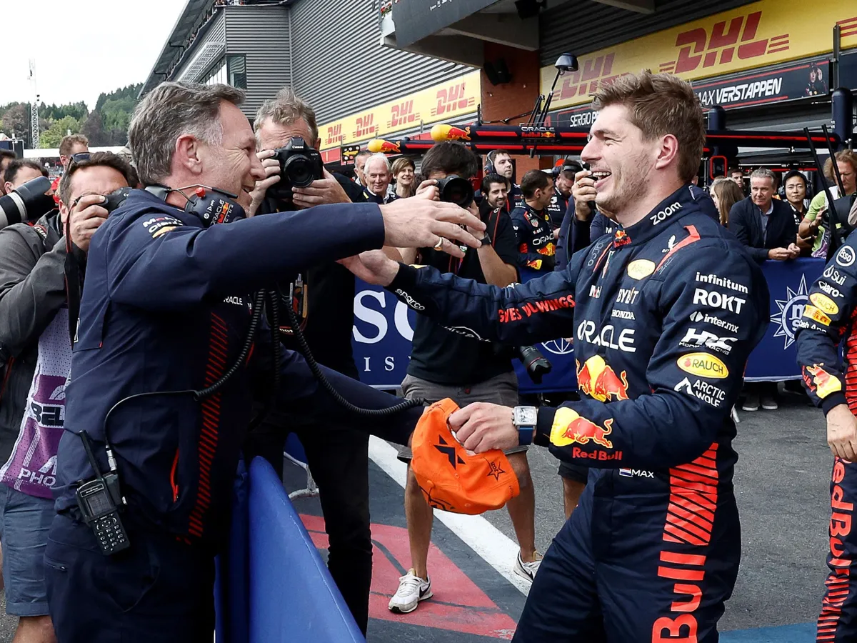 (FILES) Red Bull Racing's Dutch driver Max Verstappen (R) reacts with Red Bull Racing's British team principal Christian Horner in the parc ferme after winning the Formula One Belgian Grand Prix at the Spa-Francorchamps Circuit in Spa on July 30, 2023. Christian Horner is to leave his role as Red Bull team principal with immediate effect after 20 years, the Formula One team announced on July 9, 2025. (Photo by SIMON WOHLFAHRT / AFP)