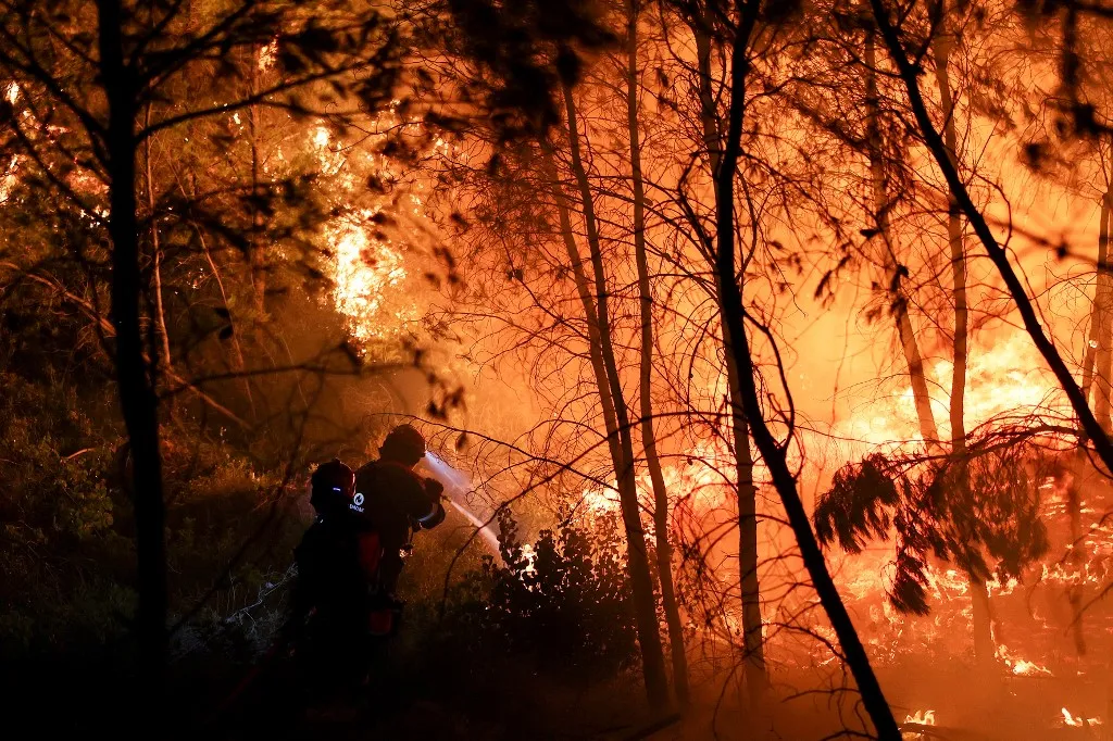 OROPOS, GREECE - JULY 9: Firefighters operate during a wildfire in Asprochori near Oropos, Greece, on July 9, 2025. Costas Baltas / Anadolu (Photo by COSTAS BALTAS / Anadolu via AFP)
