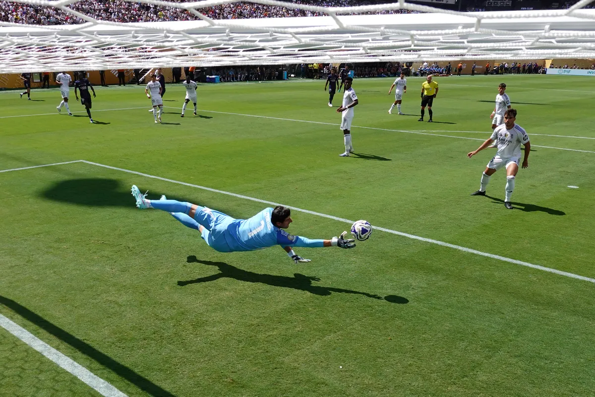 EAST RUTHERFORD, NEW JERSEY - JULY 09: (EDITOR'S NOTE: Image was captured using a remote netcam.) Thibaut Courtois #1 of Real Madrid C.F. makes a save during the FIFA Club World Cup 2025 semi-final match between Paris Saint-Germain and Real Madrid CF at MetLife Stadium on July 09, 2025 in East Rutherford, New Jersey.   Dan Mullan/Getty Images/AFP (Photo by Dan Mullan / GETTY IMAGES NORTH AMERICA / Getty Images via AFP)