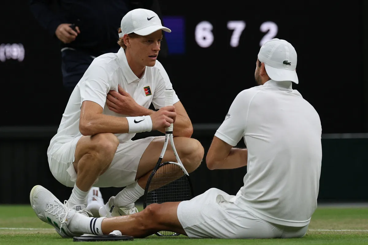 Bulgaria's Grigor Dimitrov (R) speaks with Italy's Jannik Sinner (L) after getting injured during their men's singles fourth round tennis match on the eighth day of the 2025 Wimbledon Championships at The All England Lawn Tennis and Croquet Club in Wimbledon, southwest London, on July 7, 2025. (Photo by Adrian Dennis / AFP) / RESTRICTED TO EDITORIAL USE