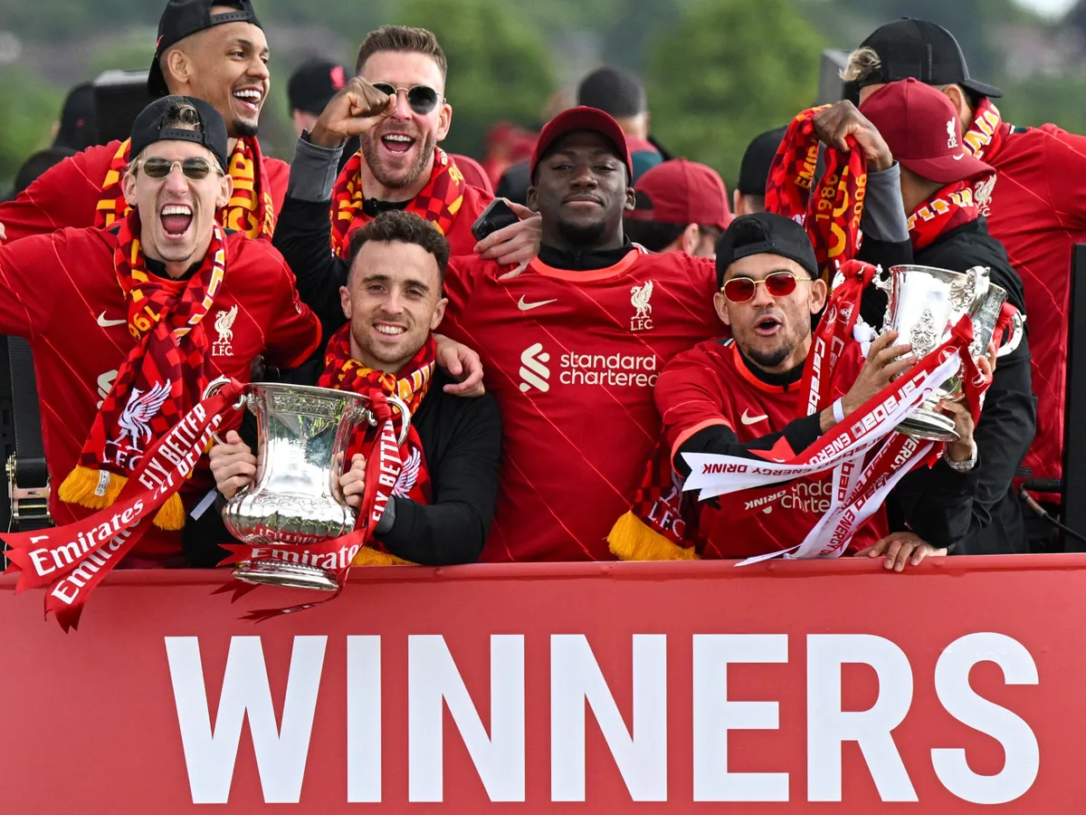 (FILES) (From L) Liverpool's Greek defender Kostas Tsimikas, Liverpool's Portuguese striker Diogo Jota, Liverpool's French defender Ibrahima Konate and Liverpool's Colombian midfielder Luis Diaz celebrate with both trophies from an open-top bus during a parade through the streets of Liverpool in north-west England on May 29, 2022, after winning the 2021-22 League Cup and FA Cup. Liverpool striker Diogo Jota died along with his brother early July 3, 2025 in a road accident in northwest Spain, the Spanish Civil Guard said. The accident occurred around 12:30 a.m. on a highway in the province of Zamora. The vehicle "left the road" before bursting into flames, the Civil Guard said, adding that the two passengers, Diogo Jota and his brother Andre Felipe, also a professional footballer, were deceased. (Photo by Oli SCARFF / AFP)